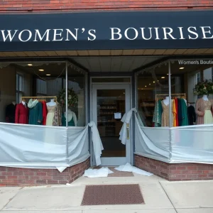 Front view of Tapestry Inc. boutique showing damage after break-in