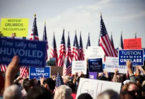 Political rally with flags and signs representing different movements.