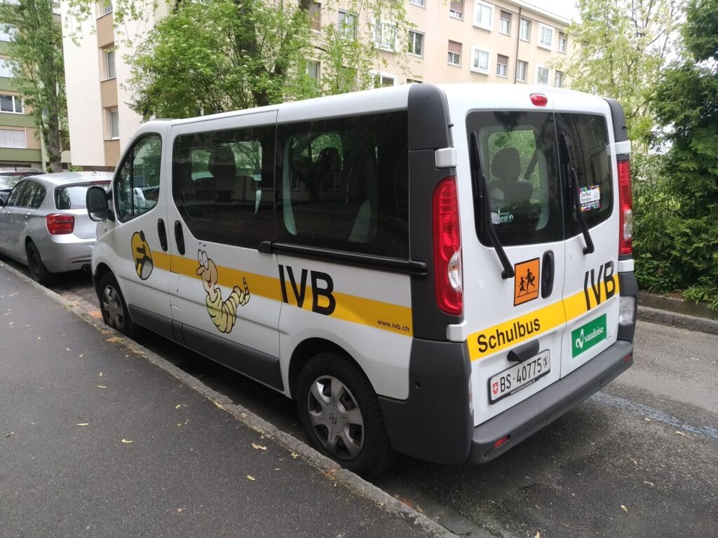 Small school bus parked on a street
