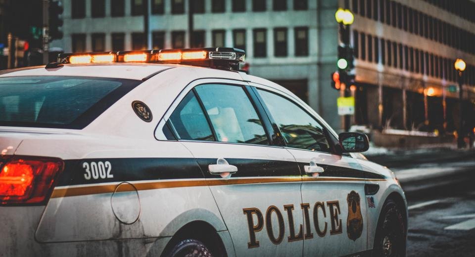 Police car lights on a roadway at dusk