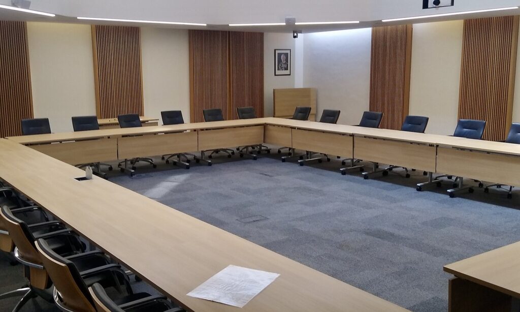 Empty council chamber with long tables